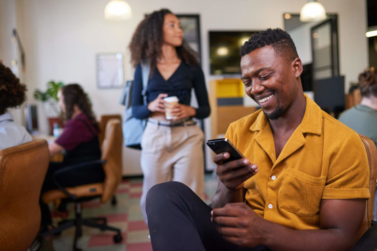 happy employee looking at phone